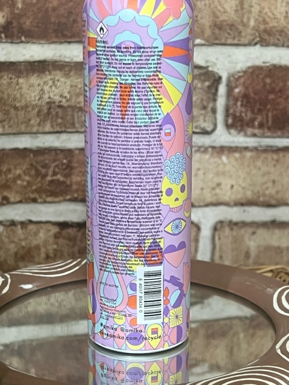 amika body mousse in pink, purple & yellow patterned bottle